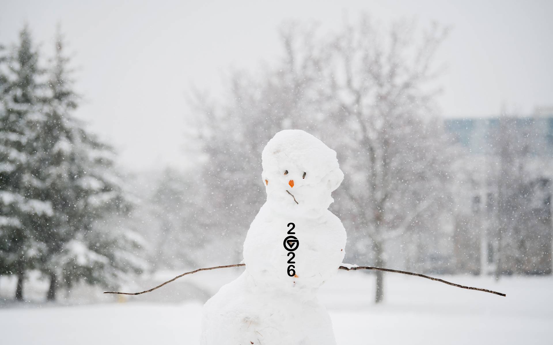 Snowman with buttons down the front in the shape of 2026.
